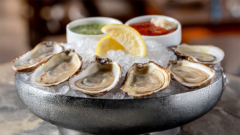 Oysters on ice with slices of lemon
