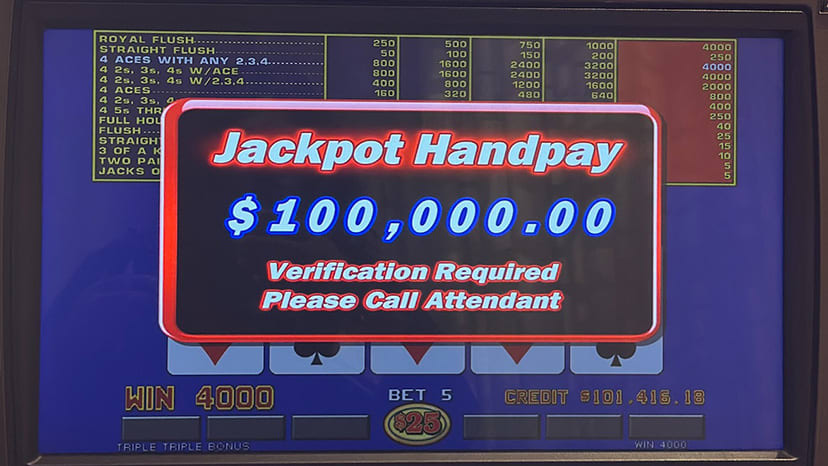 A video poker screen showing a winner of $100,000