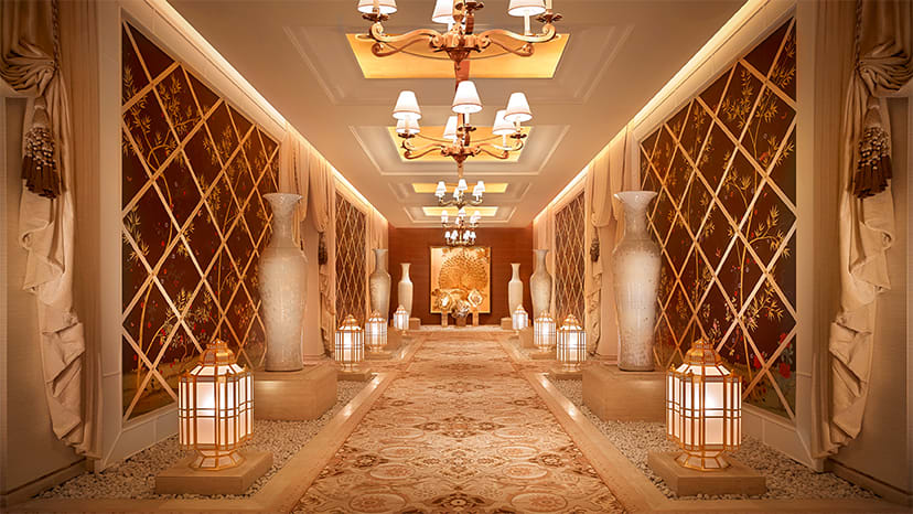 A hallway with lights leading to the Spa at Encore Boston Harbor