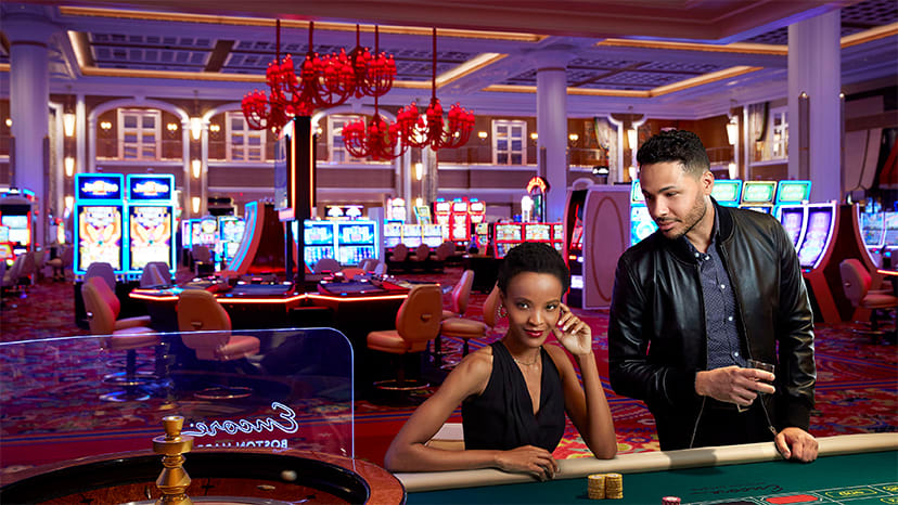 Two people play roulette at Encore Boston Harbor