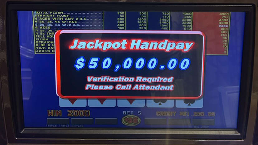 A slot machine screen showing a $50,000 jackpot winner