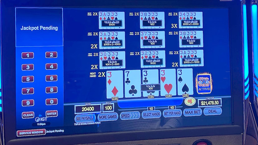 A slot machine screen showing a winning hand in video poker