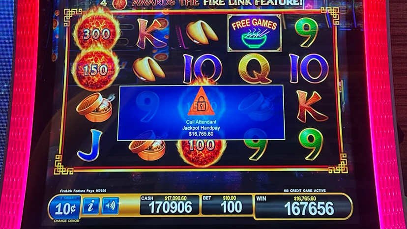 A slot machine screen showing slot reels with a $16,765 winner