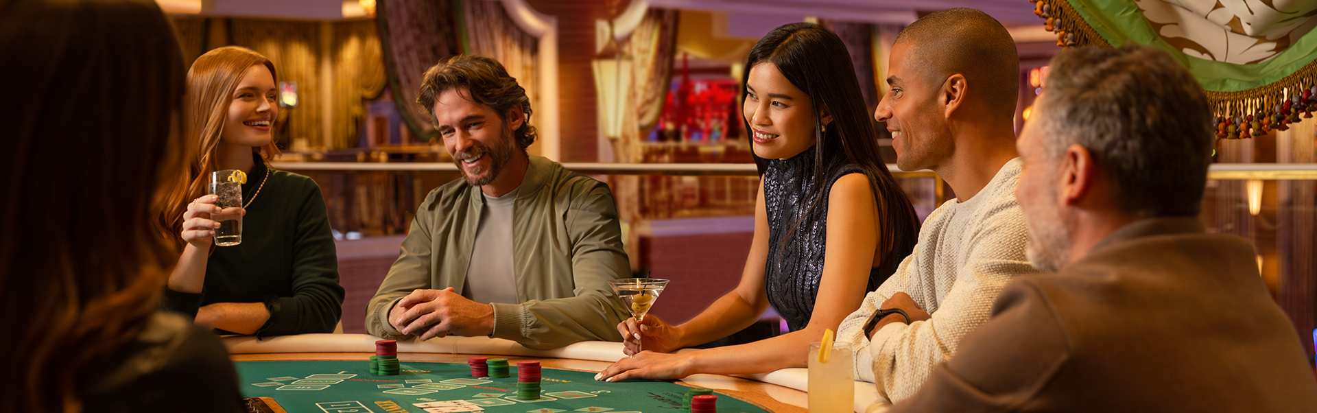 Guests sit and play at a baccarat table