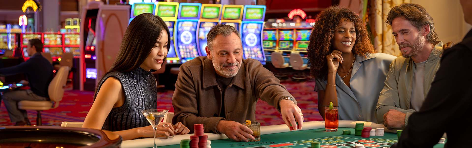 A group of people are sitting and playing roulette