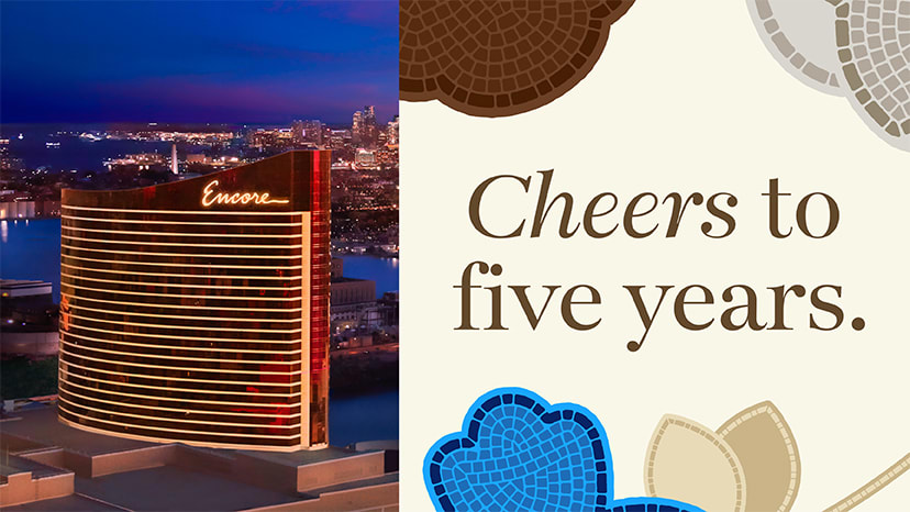 Exterior of Encore Boston Harbor with banner that reads Cheers to five years